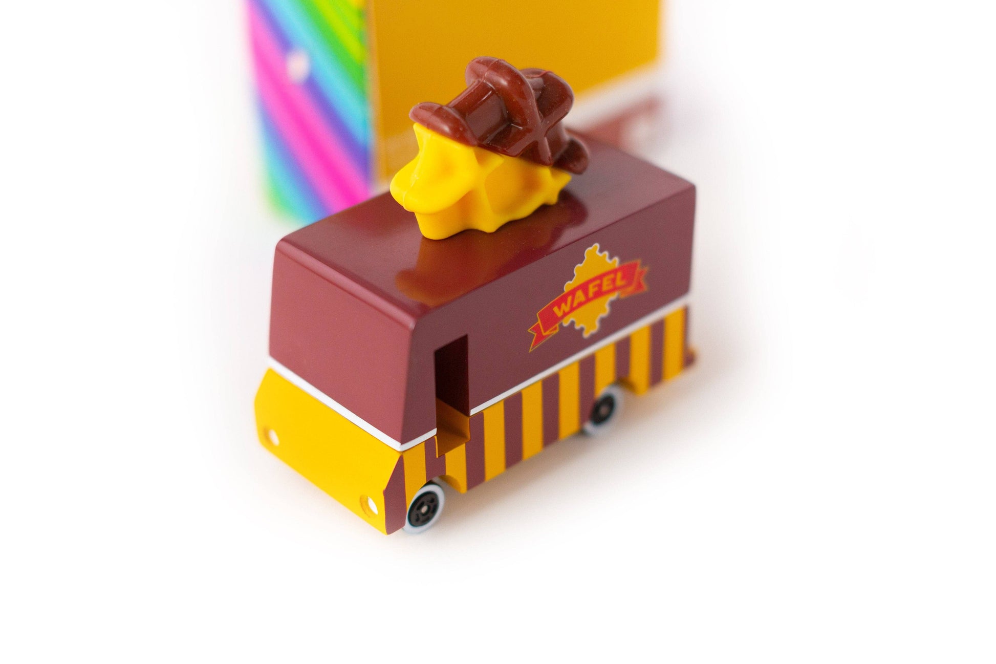 Toy ice cream truck with a brown roof and yellow body on a white background